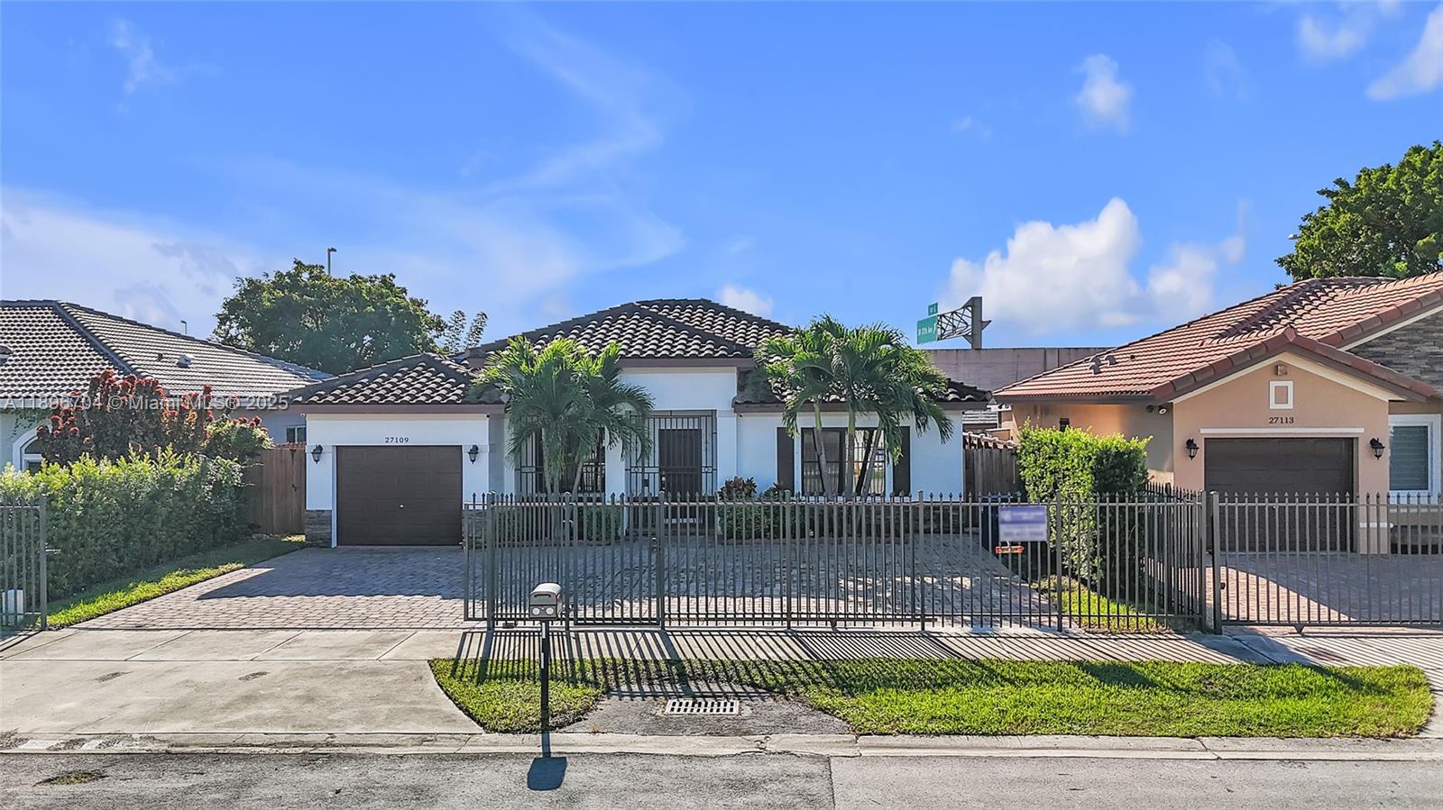 27109 Southwest 133rd Court Homestead, FL 33032 - Photo 4 of 48 a front view of a house with garden