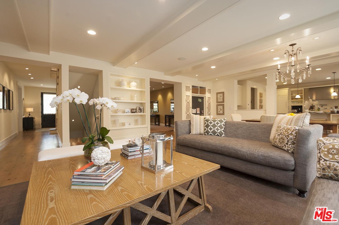 753 Ocampo Drive Pacific Palisades, CA 90272 - Photo 15 of 53 a living room with furniture kitchen view and a chandelier
