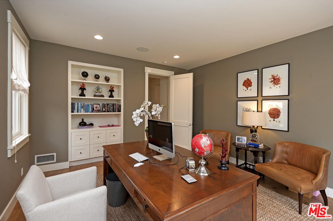 753 Ocampo Drive Pacific Palisades, CA 90272 - Photo 28 of 53 a living room with furniture a chandelier and a flat screen tv