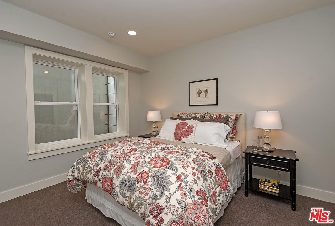 753 Ocampo Drive Pacific Palisades, CA 90272 - Photo 29 of 53 a bedroom with a bed and a lamp on table
