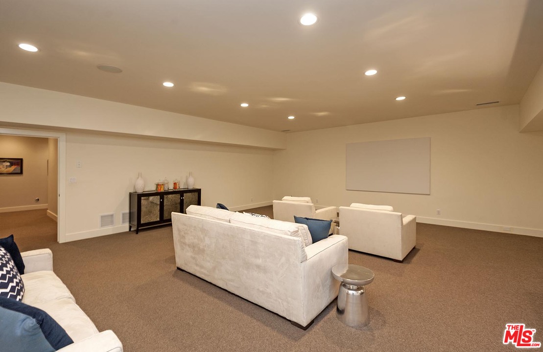 753 Ocampo Drive Pacific Palisades, CA 90272 - Photo 31 of 53 a living room with couches and a table with potted plant
