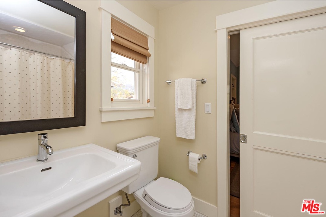 753 Ocampo Drive Pacific Palisades, CA 90272 - Photo 33 of 53 a bathroom with a sink a toilet and a mirror