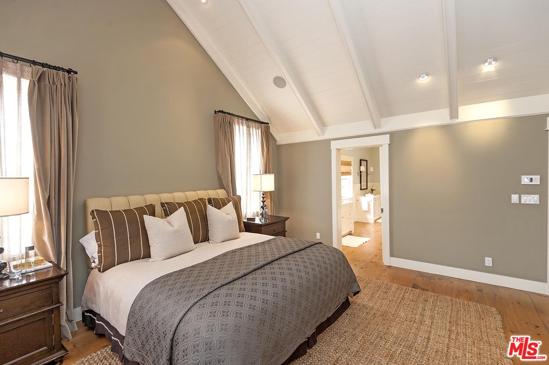 753 Ocampo Drive Pacific Palisades, CA 90272 - Photo 35 of 53 a bedroom with a large bed and a large window