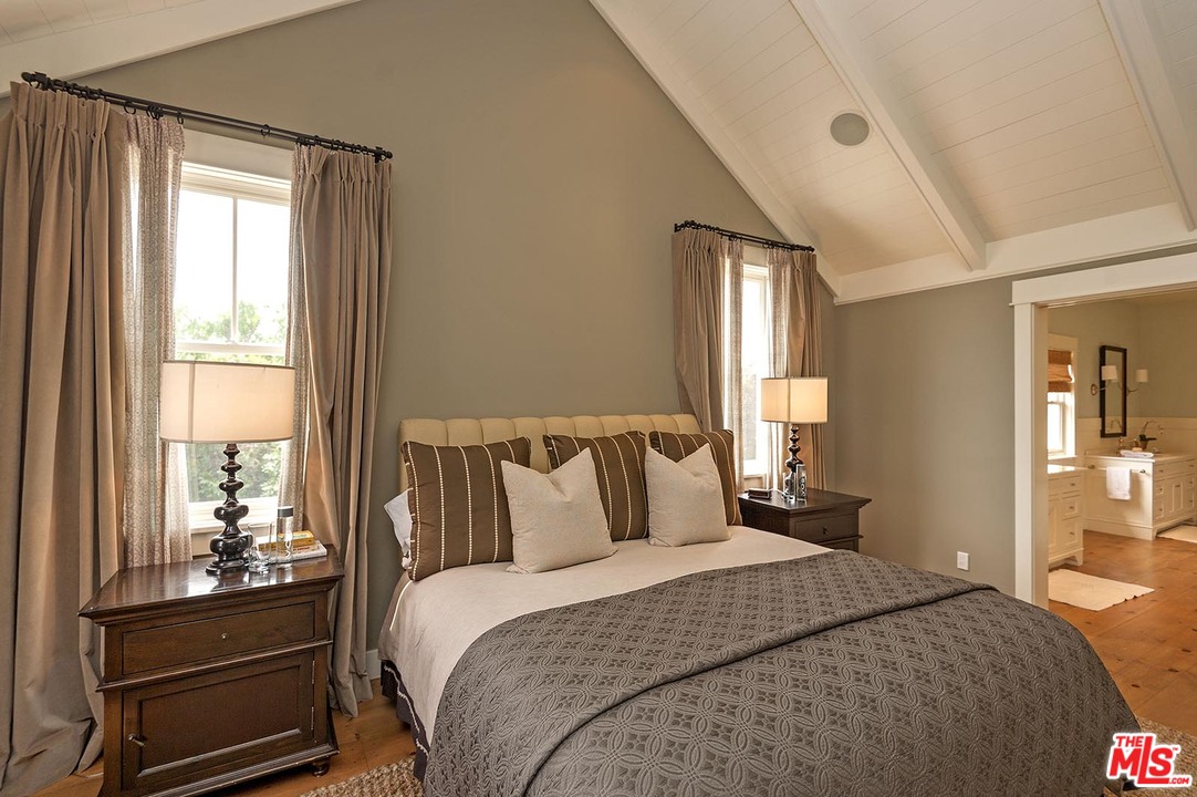 753 Ocampo Drive Pacific Palisades, CA 90272 - Photo 37 of 53 a bedroom with a bed and large window