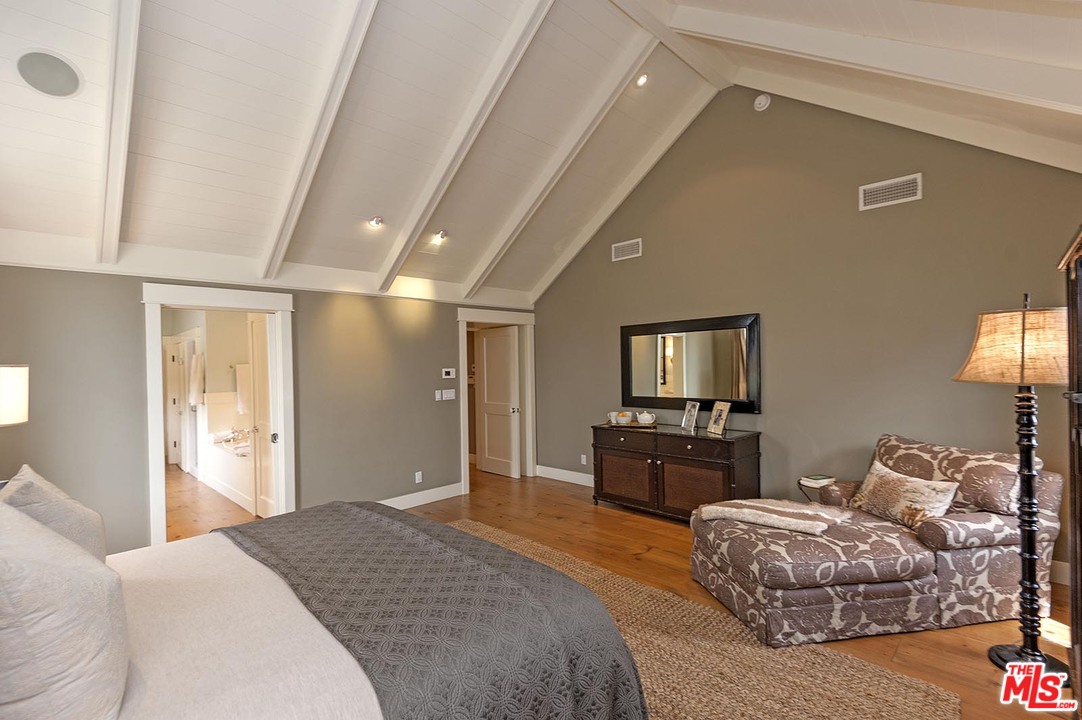 753 Ocampo Drive Pacific Palisades, CA 90272 - Photo 38 of 53 a spacious bedroom with a bed and dresser