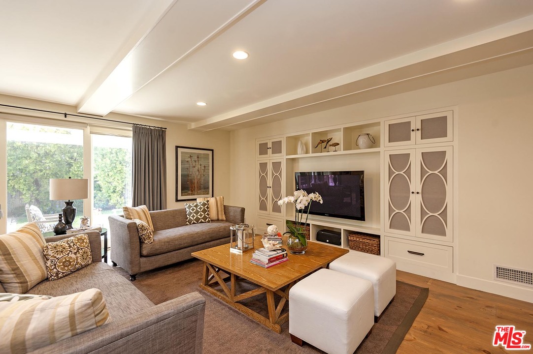 753 Ocampo Drive Pacific Palisades, CA 90272 - Photo 10 of 53 a living room with furniture flat screen tv and a large window