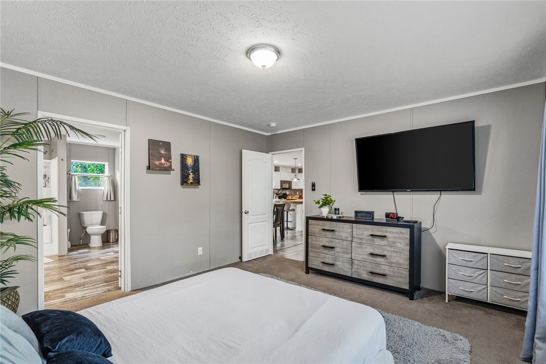 429 Gibson Road Anderson, SC 29625 - Photo 22 of 47 An inviting bedroom layout features soft wall tones alongside an adjacent private bathroom.