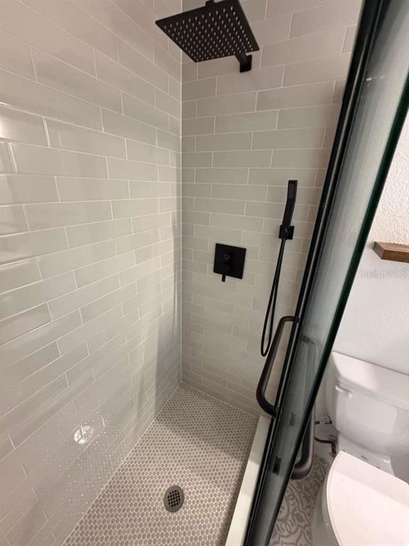 2312 Southwest Fort King Street Ocala, FL 34471 - Photo 11 of 17 a bathroom with a shower and toilet