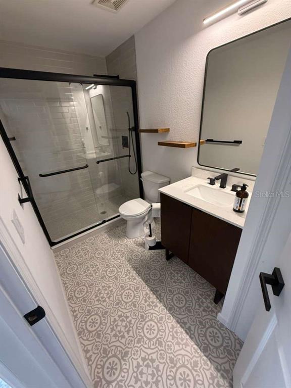 2312 Southwest Fort King Street Ocala, FL 34471 - Photo 12 of 17 a bathroom with a sink toilet and mirror