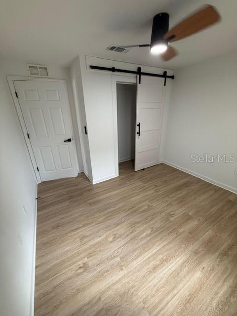 2312 Southwest Fort King Street Ocala, FL 34471 - Photo 3 of 17 an empty room with wooden floor and windows