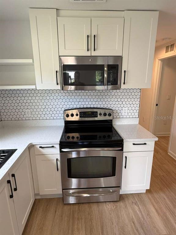 2312 Southwest Fort King Street Ocala, FL 34471 - Photo 9 of 17 a white stove top oven sitting inside of a kitchen