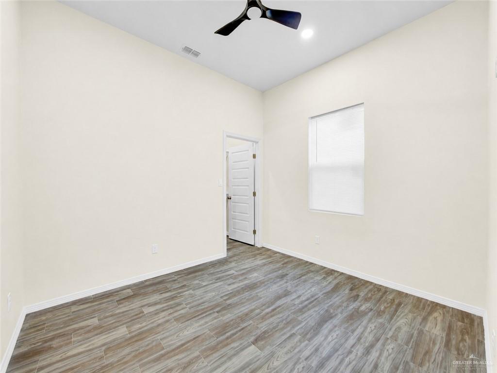 618 West 25th Street Mission, TX 78574 - Photo 6 of 8 Interior room with wood-finish flooring, light-toned walls, and a contemporary ceiling fan