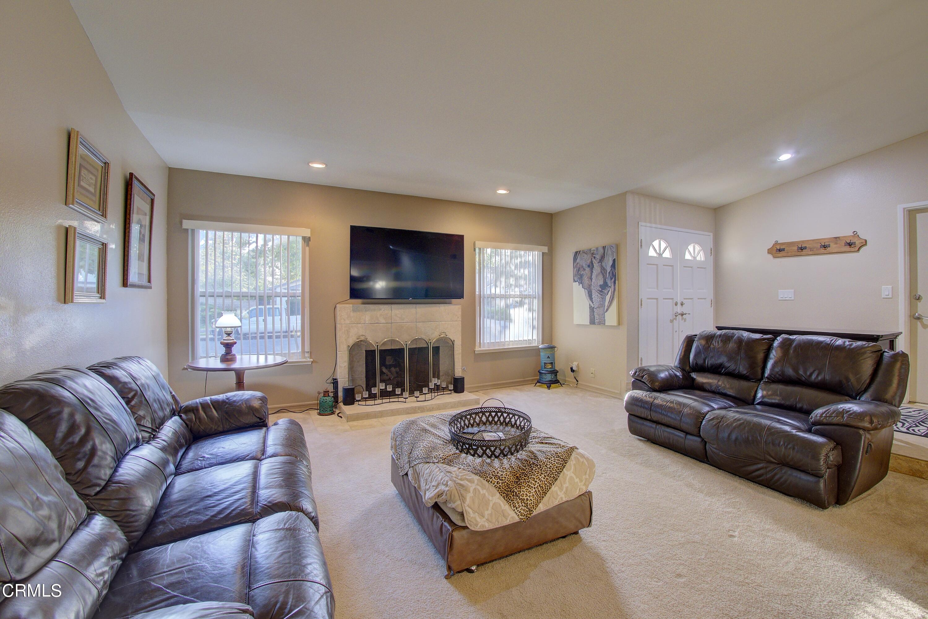 2606 Wheatfield Circle Simi Valley, CA 93063 - Photo 46 of 60 a living room with furniture a large window and a fireplace