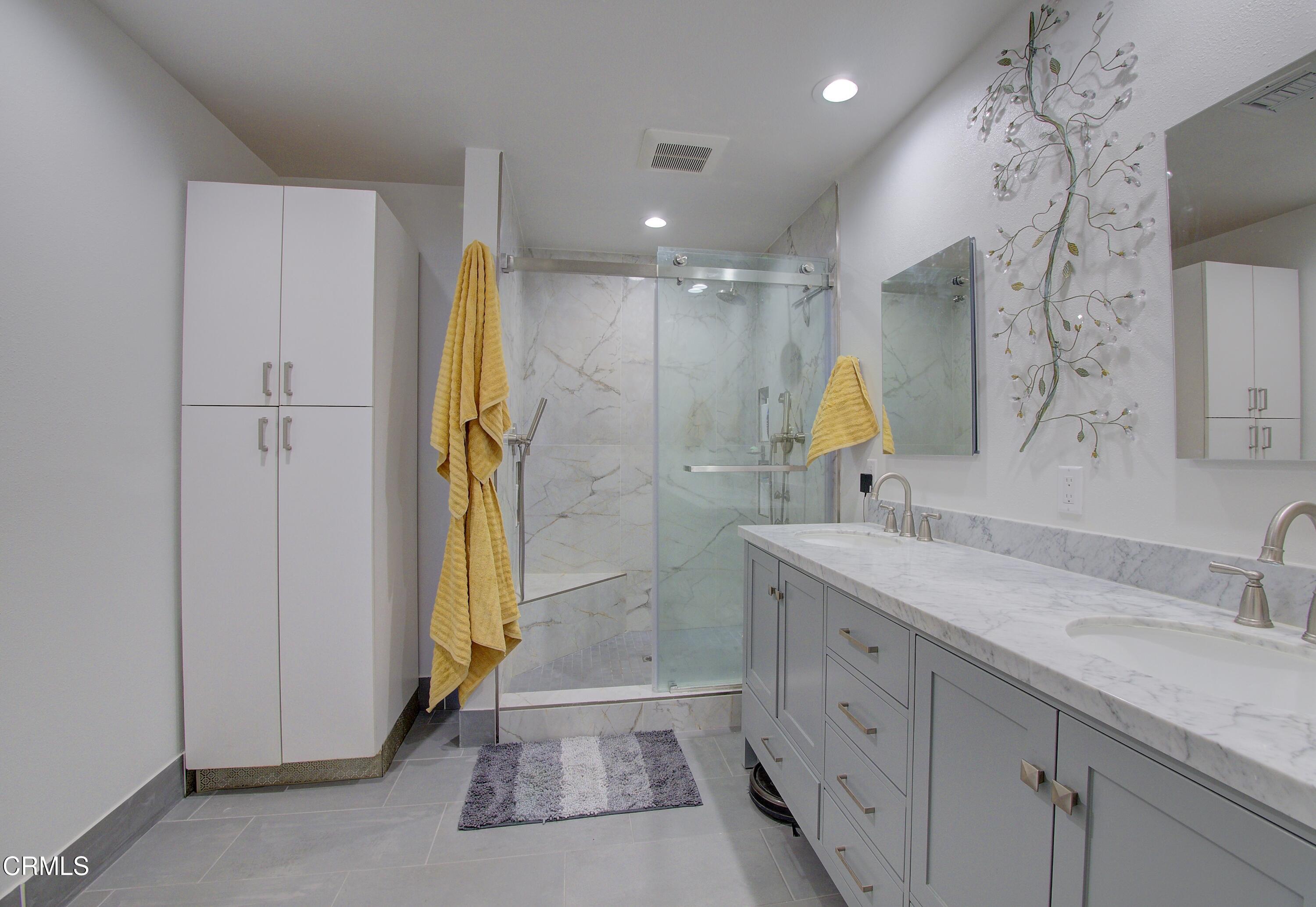 2606 Wheatfield Circle Simi Valley, CA 93063 - Photo 57 of 60 a bathroom with a double vanity sink and a mirror