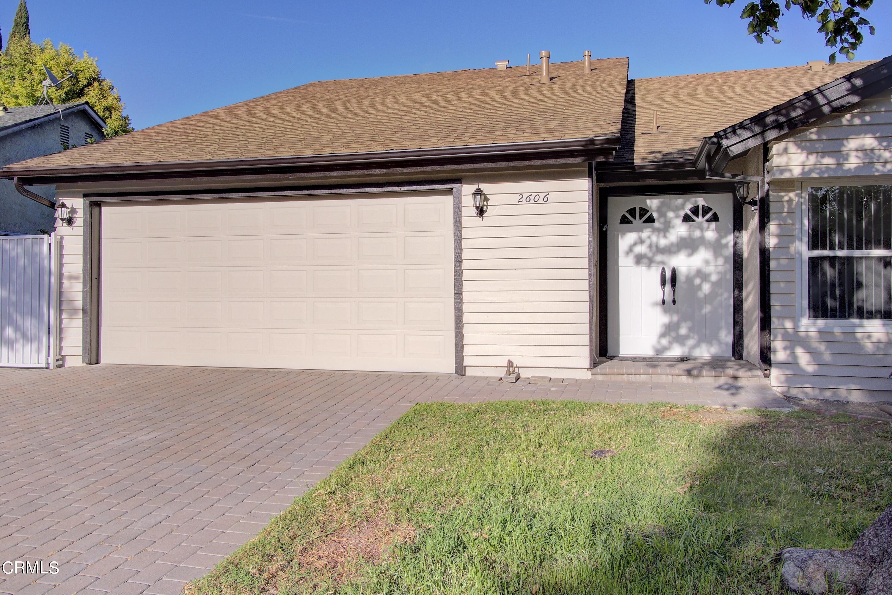 2606 Wheatfield Circle Simi Valley, CA 93063 - Photo 7 of 60 a front view of a house with a garden and plants