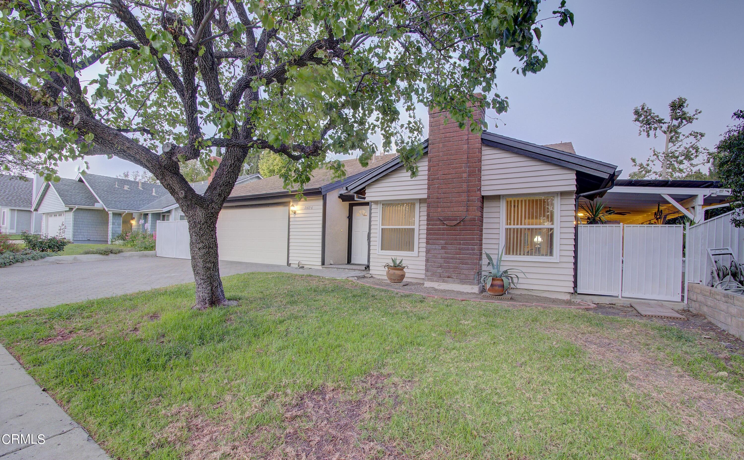 2606 Wheatfield Circle Simi Valley, CA 93063 - Photo 9 of 60 a tree in front of a white house
