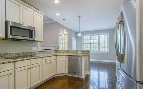 an empty room with a window and a ceiling fan
