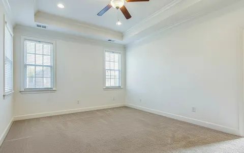 an empty room with a empty space and a ceiling fan