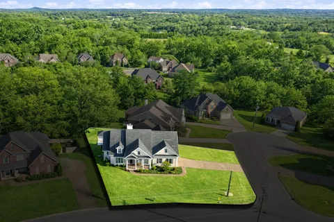 a view of a swimming pool with lawn chairs and a fire pit