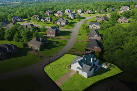 an aerial view of a house with a yard