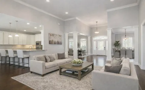a view of a kitchen with cabinets and wooden floor