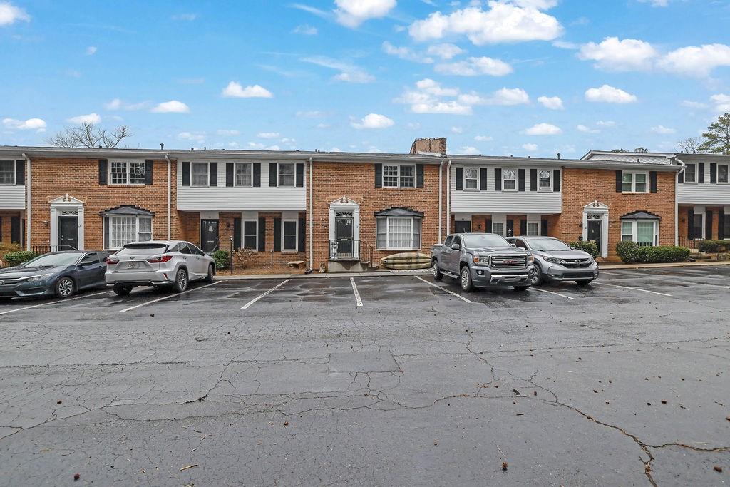 a building with parking space and a car parked