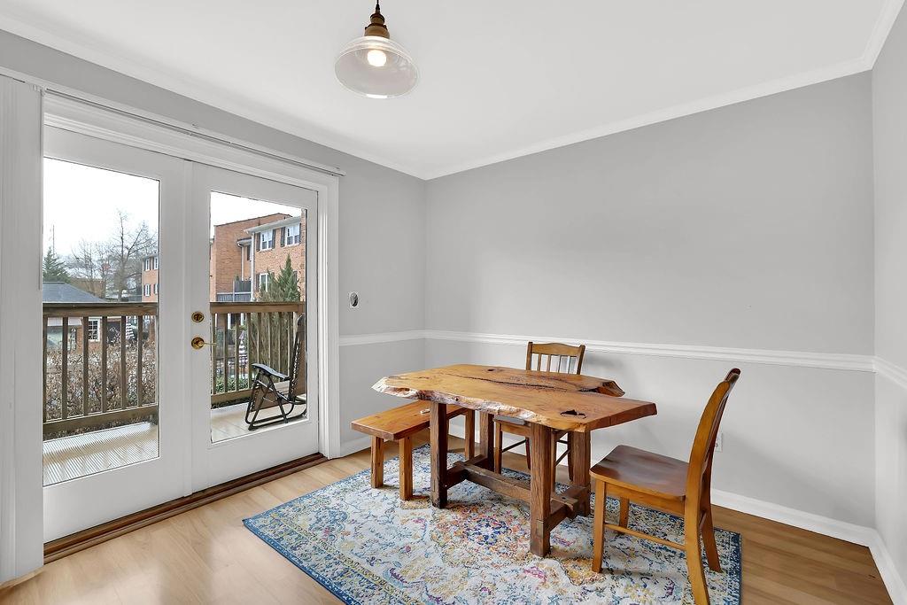6520 Roswell Road, Unit 62 Atlanta, GA 30328 - Photo 11 of 34 a view of a dining room with furniture wooden floor and a potted plant
