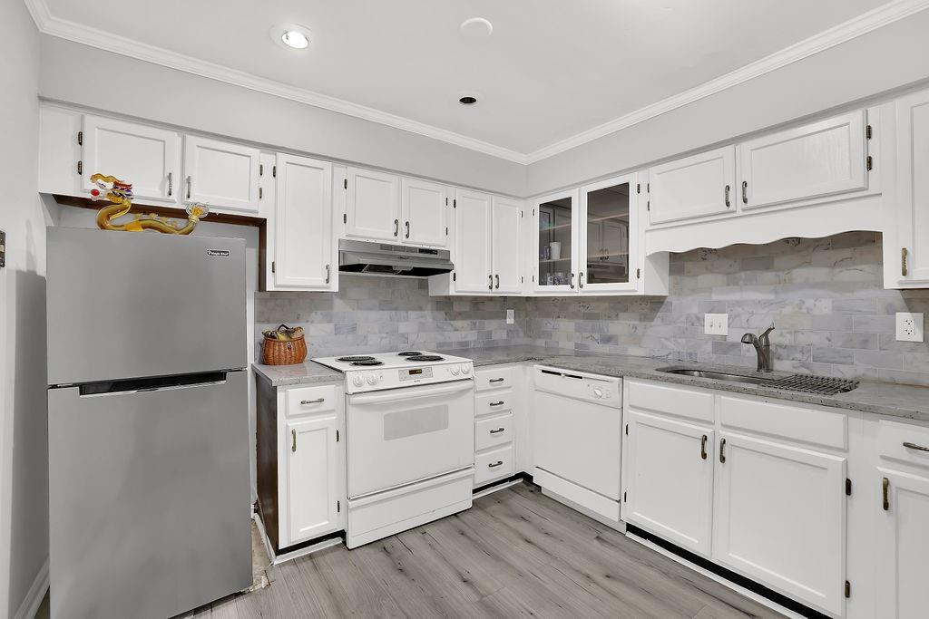 6520 Roswell Road, Unit 62 Atlanta, GA 30328 - Photo 15 of 34 a kitchen with stainless steel appliances granite countertop a refrigerator sink and cabinets