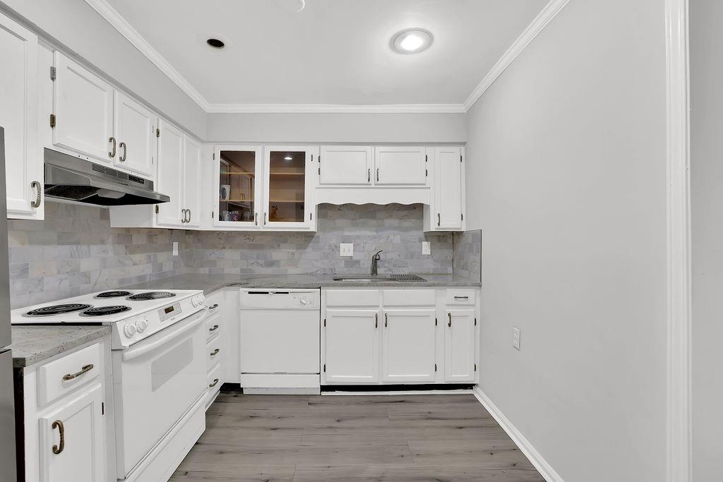6520 Roswell Road, Unit 62 Atlanta, GA 30328 - Photo 16 of 34 a kitchen with stainless steel appliances granite countertop a stove and white cabinets