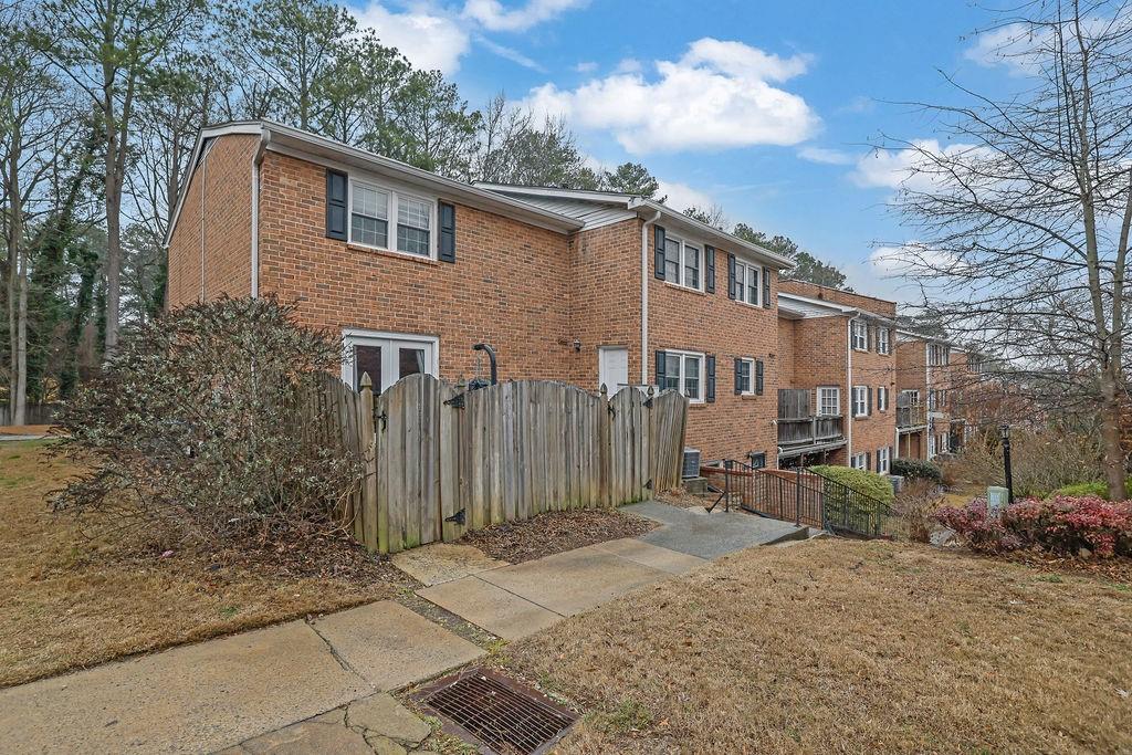 6520 Roswell Road, Unit 62 Atlanta, GA 30328 - Photo 27 of 34 a front view of a house with a yard