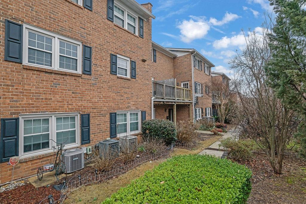 6520 Roswell Road, Unit 62 Atlanta, GA 30328 - Photo 28 of 34 a front view of a house with garden