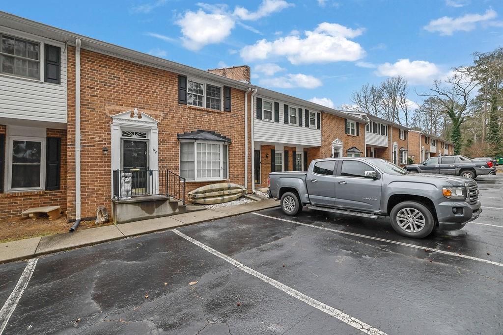 6520 Roswell Road, Unit 62 Atlanta, GA 30328 - Photo 3 of 34 a front view of a house with parking space