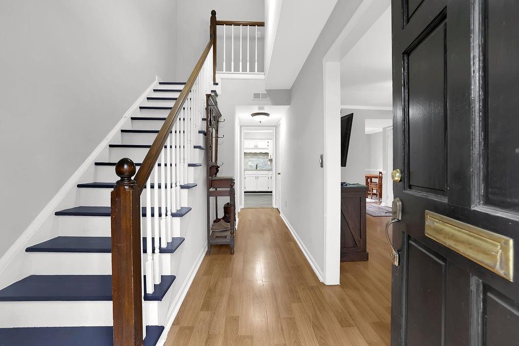6520 Roswell Road, Unit 62 Atlanta, GA 30328 - Photo 5 of 34 a view of a hallway with wooden floor and staircase