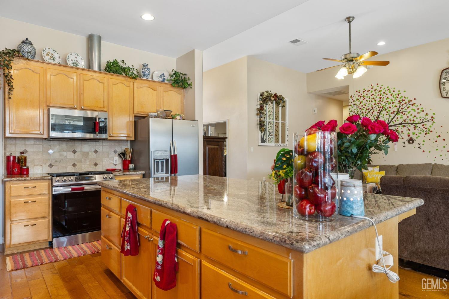 Undisclosed Address Bakersfield, CA 93313 - Photo 17 of 49 a kitchen with granite countertop a sink cabinets and stainless steel appliances