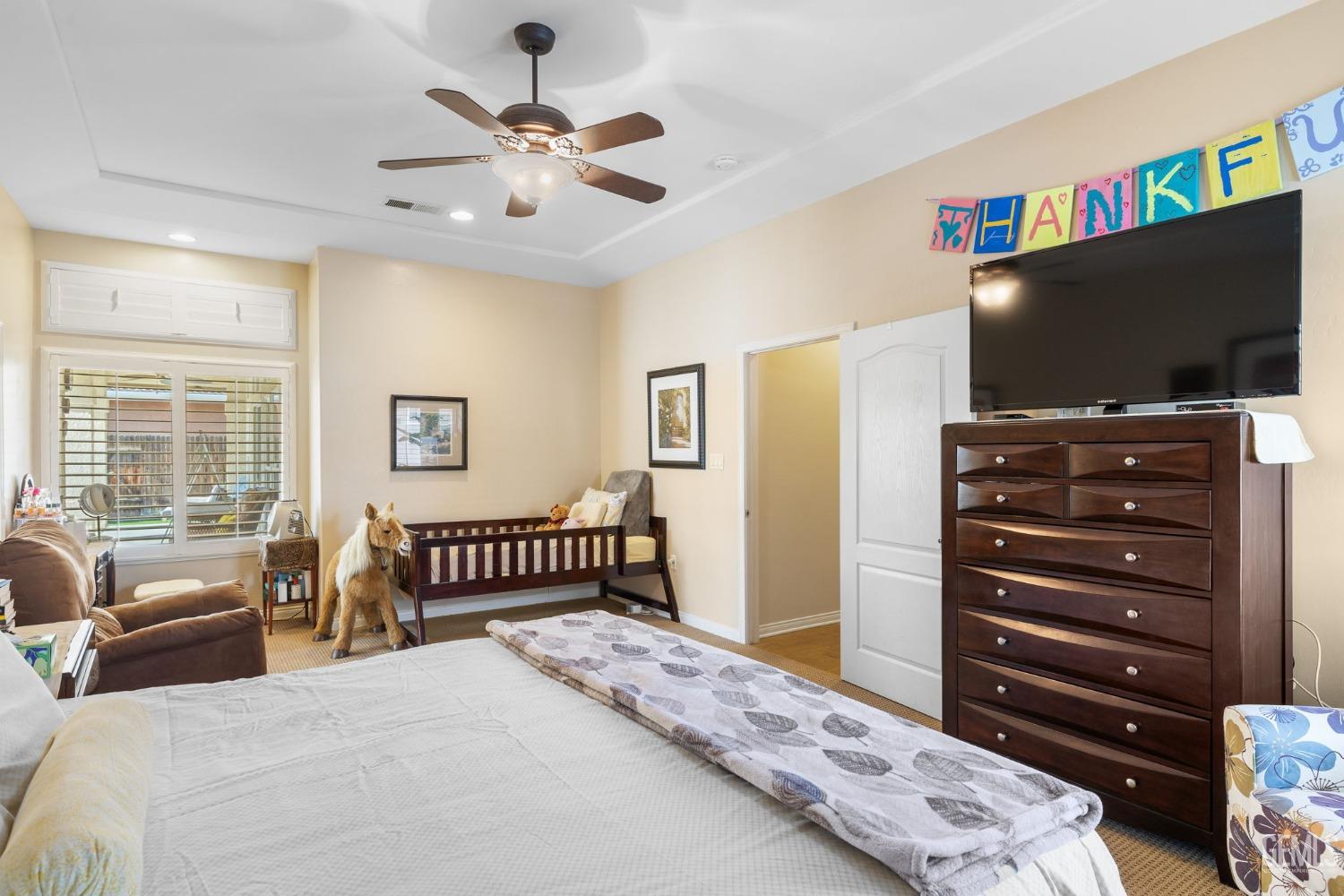 Undisclosed Address Bakersfield, CA 93313 - Photo 28 of 49 a bedroom with a bed and a flat screen tv