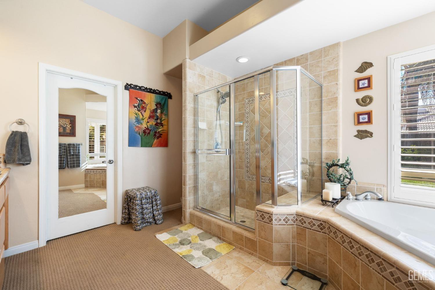 Undisclosed Address Bakersfield, CA 93313 - Photo 30 of 49 a spacious bathroom with a granite countertop tub and a large mirror