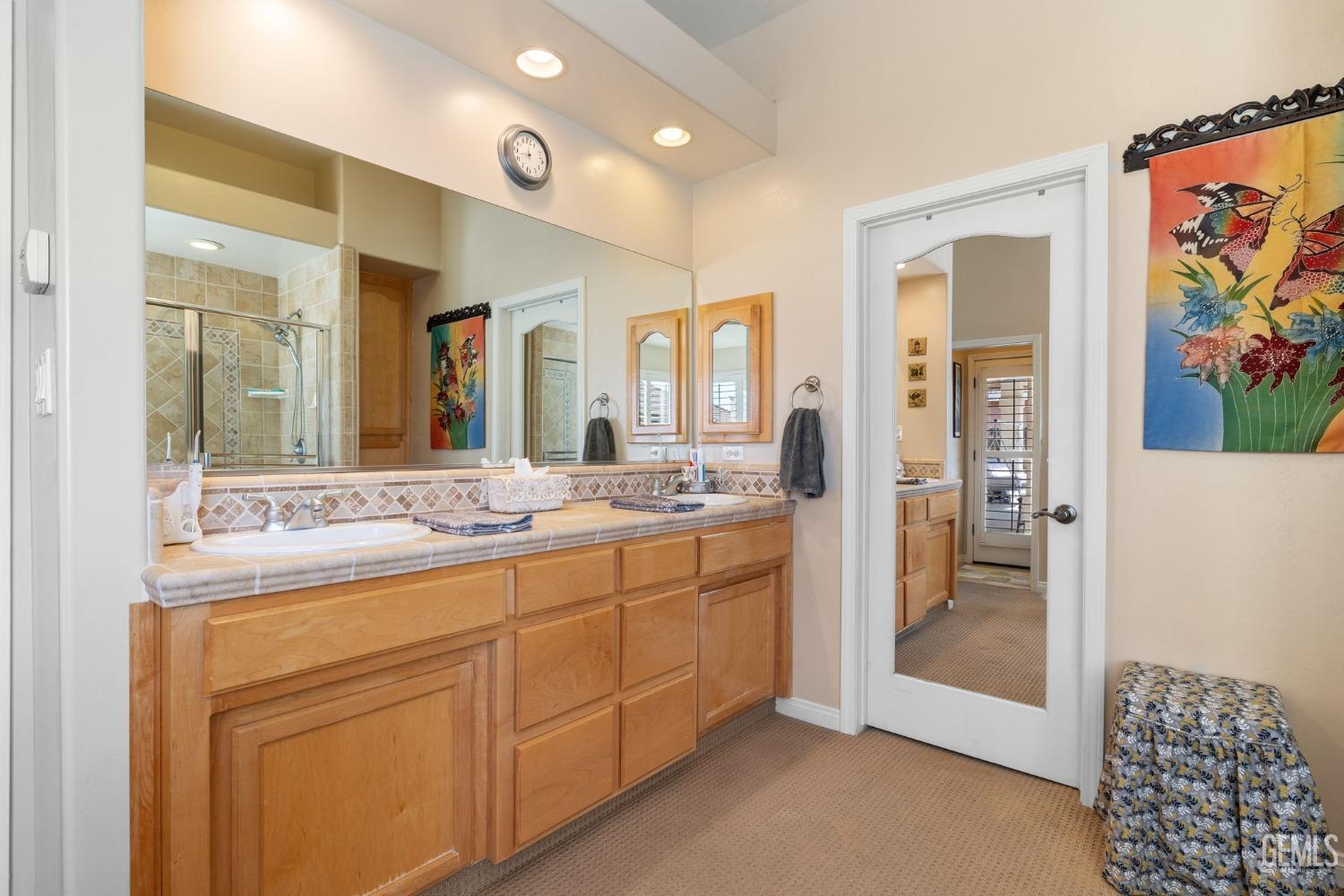 Undisclosed Address Bakersfield, CA 93313 - Photo 31 of 49 a spacious bathroom with a granite countertop sink mirror and shower
