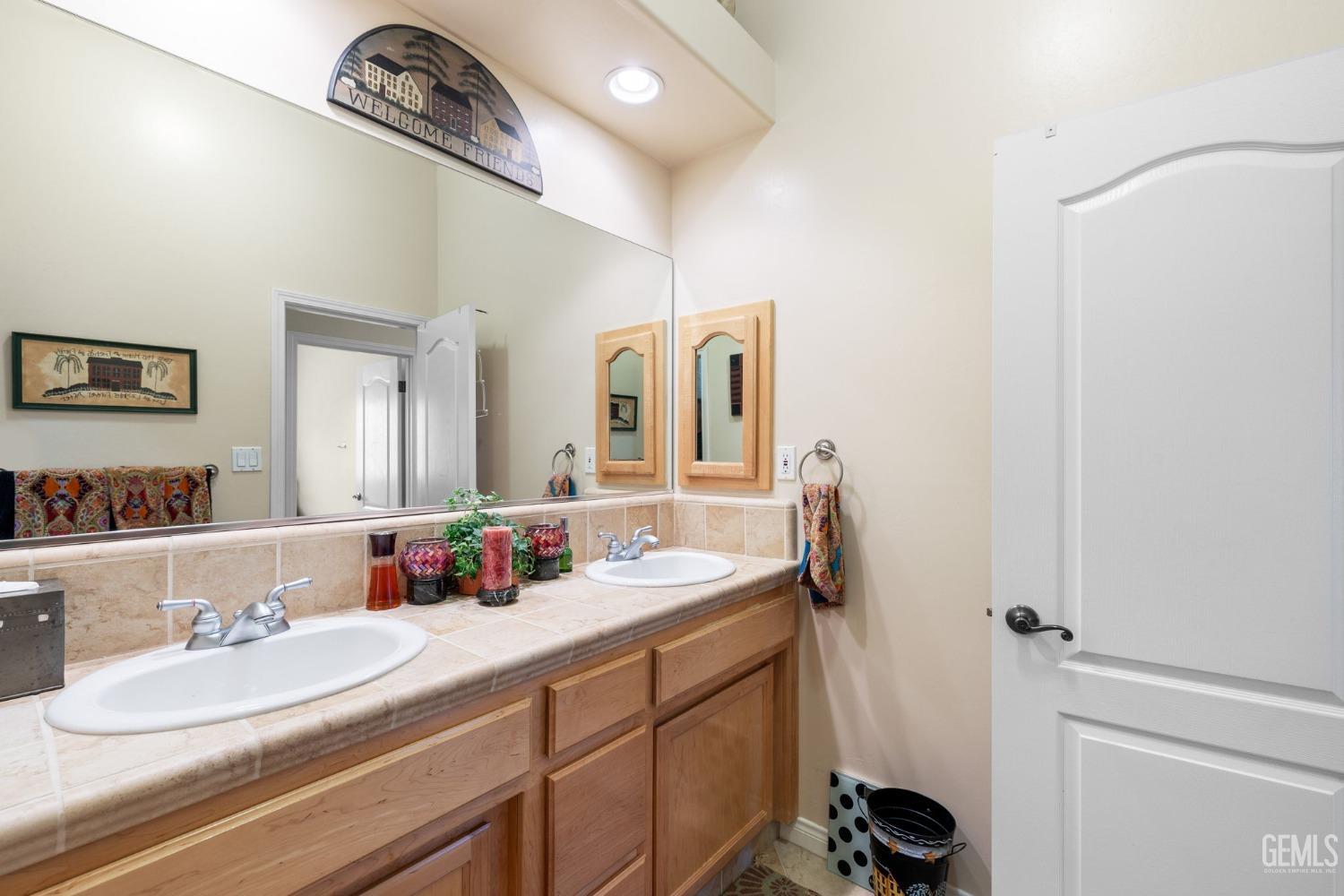 Undisclosed Address Bakersfield, CA 93313 - Photo 35 of 49 a bathroom with a sink and a mirror