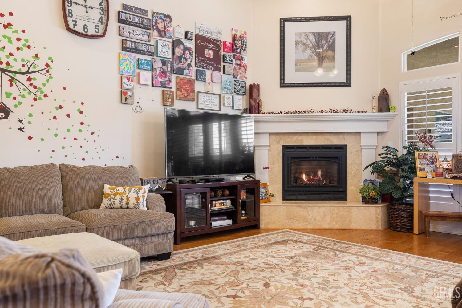 Undisclosed Address Bakersfield, CA 93313 - Photo 9 of 49 a living room with furniture and a fireplace