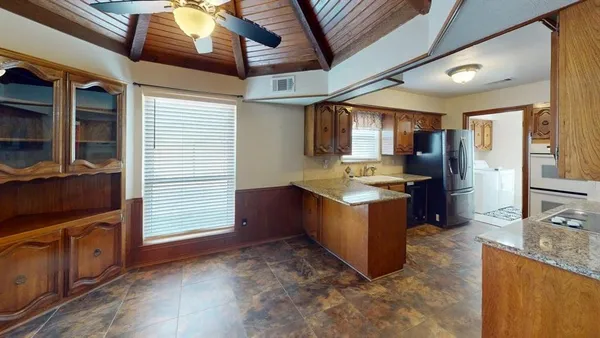 a kitchen with stainless steel appliances granite countertop a stove a sink and a refrigerator