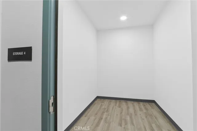 a view of a small space with wooden floor and a window