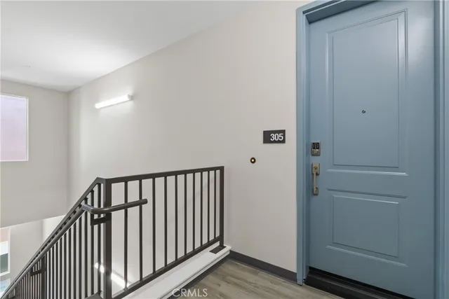 a view of hallway with wooden floor