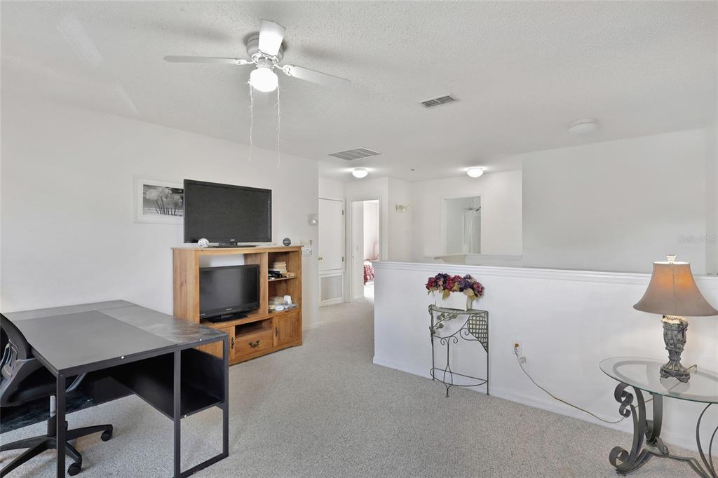 16816 Rising Star Drive Clermont, FL 34714 - Photo 14 of 21 a view of a workspace with furniture and a flat screen tv