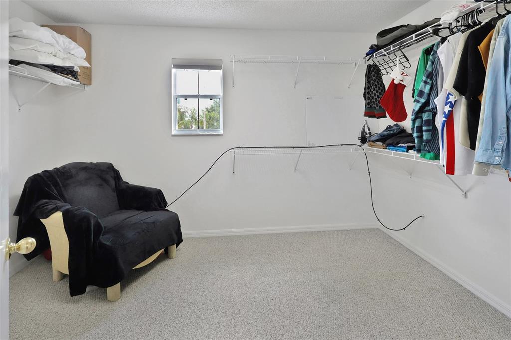 16816 Rising Star Drive Clermont, FL 34714 - Photo 16 of 21 a view of walk in closet with clothes and shoes