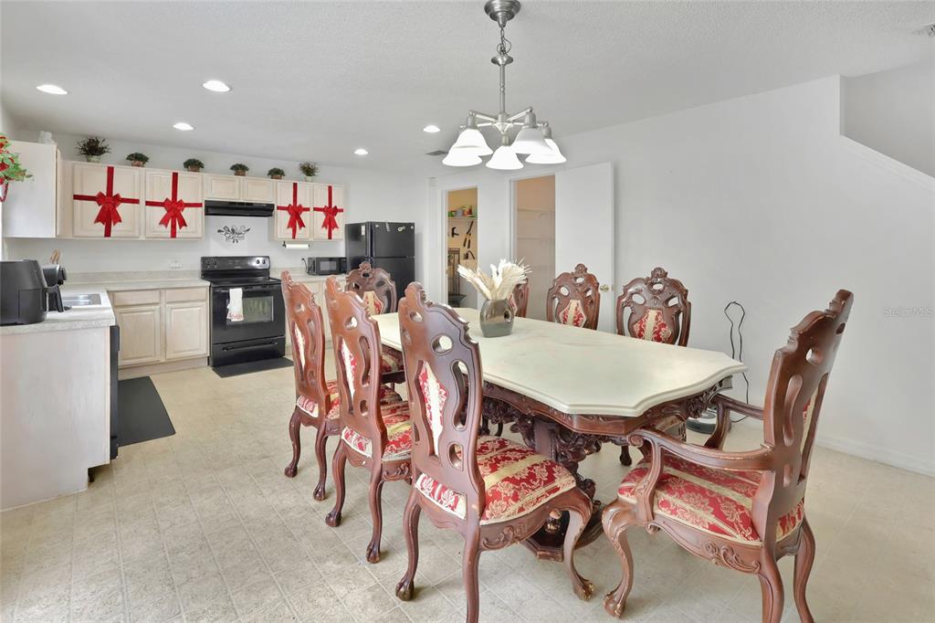 16816 Rising Star Drive Clermont, FL 34714 - Photo 10 of 21 a view of a dining room and livingroom with furniture a chandelier a wooden table and chairs