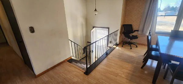 a view of hallway with wooden floor