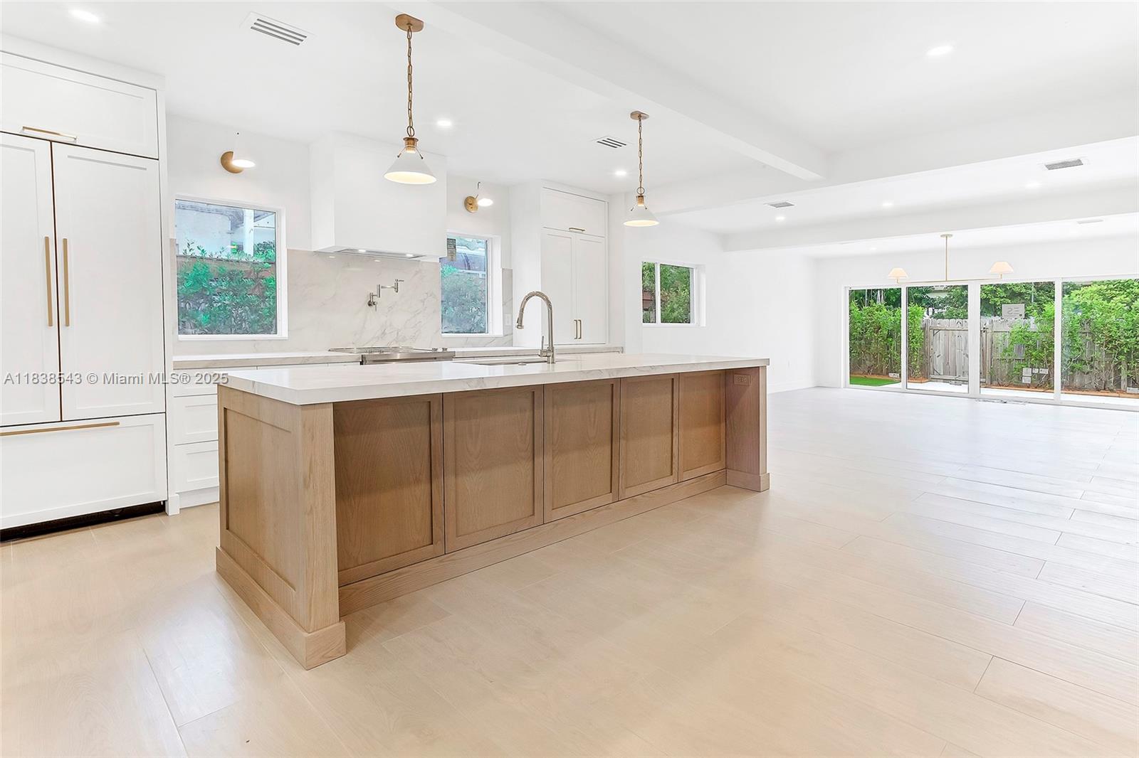 Normandy Isle Miami Beach, FL 33141 - Photo 14 of 43 a large white kitchen with a sink and dishwasher with white cabinets