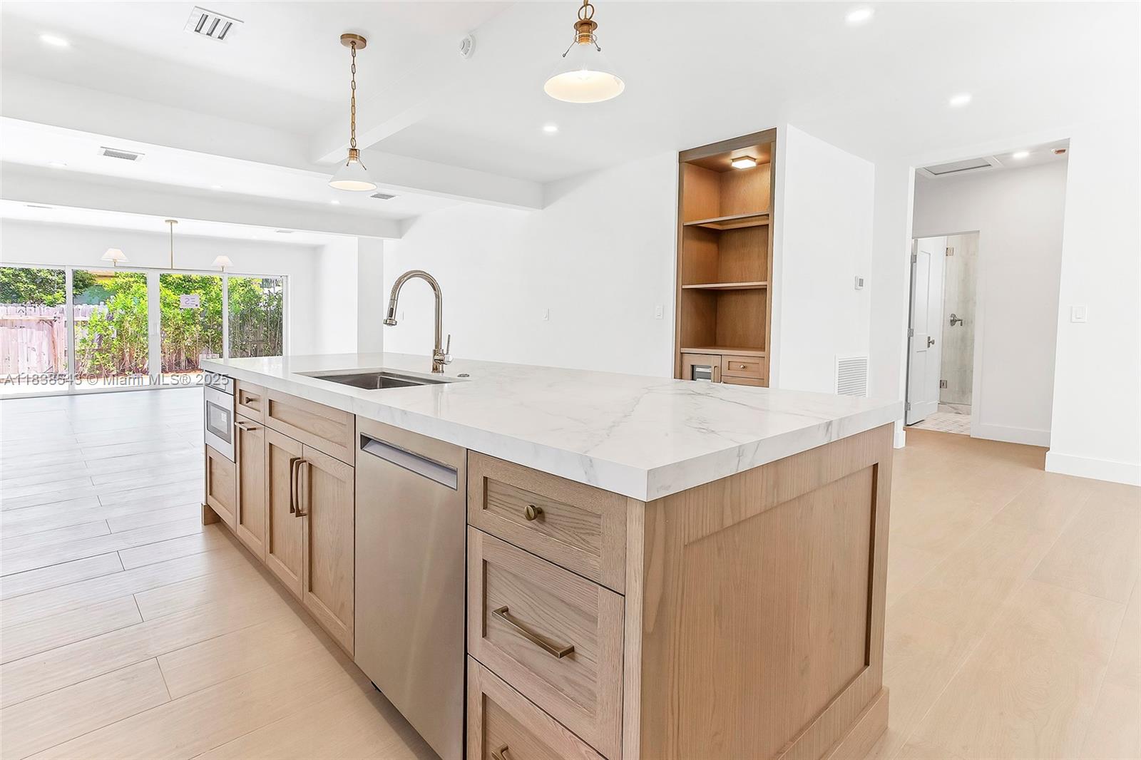 Normandy Isle Miami Beach, FL 33141 - Photo 15 of 43 a kitchen with white cabinets and window