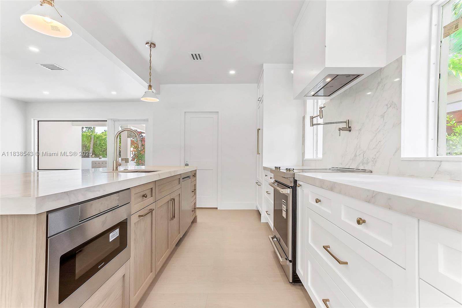 Normandy Isle Miami Beach, FL 33141 - Photo 18 of 43 a large kitchen with a large counter top sink and stainless steel appliances