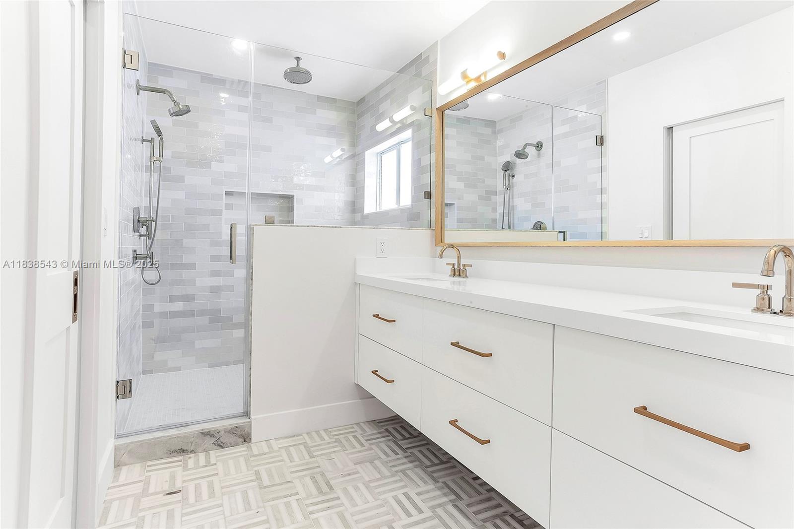 Normandy Isle Miami Beach, FL 33141 - Photo 19 of 43 a bathroom with a shower sink and mirror